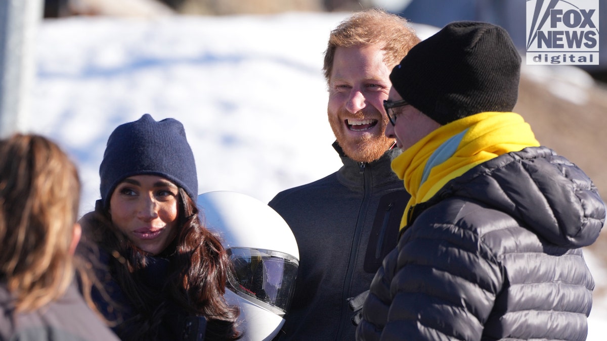 Prince Harry and Meghan Markle talking to people