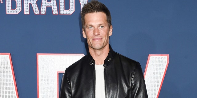 Tom Brady wears leather jacket and white T-shirt on red carpet of film premiere