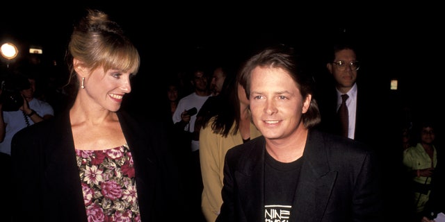 Michael J. Fox holds hands with wife Tracy Pollan in 1991.