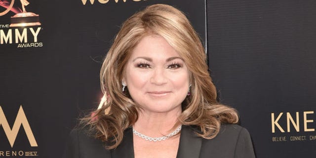 Valerie Bertinelli smiles at a red carpet event.